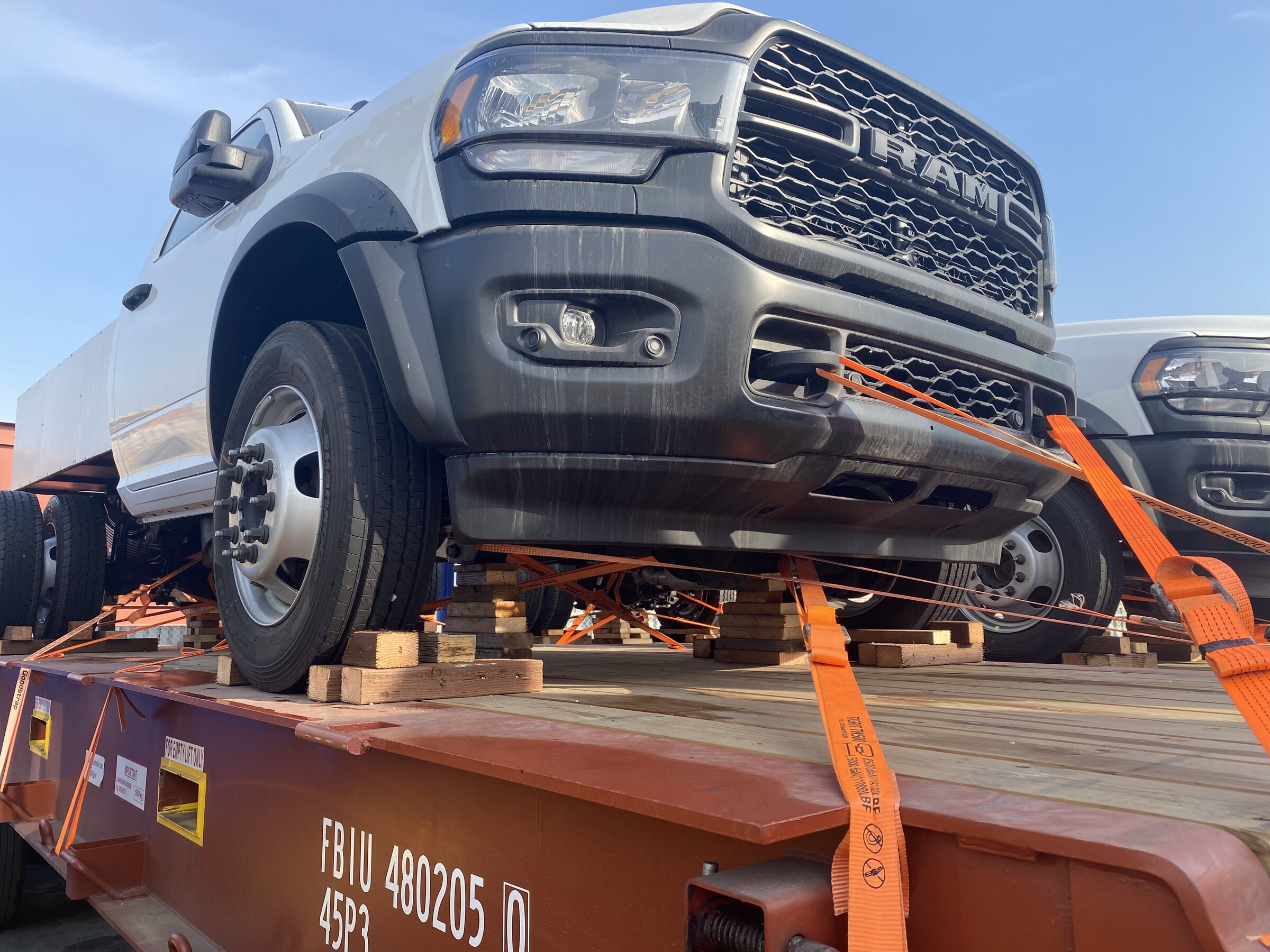 Industrial equipment ratchet-strapped on flatbed